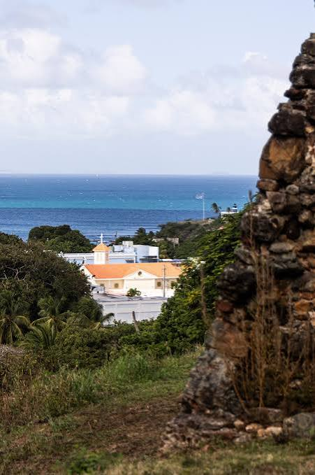 View toward town and the ocean through old stone walls