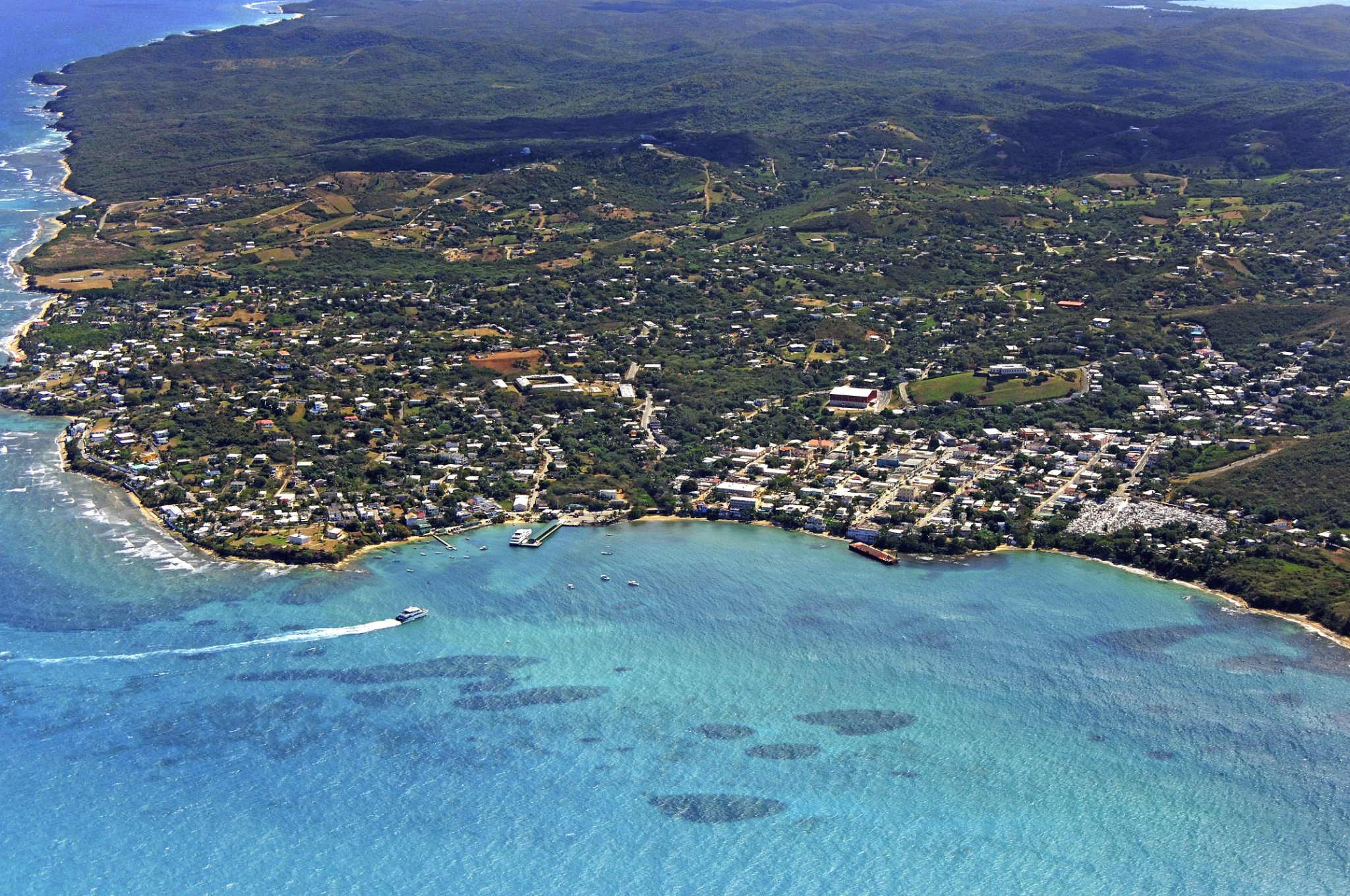 A sweeping aerial view of the coast and inland hills